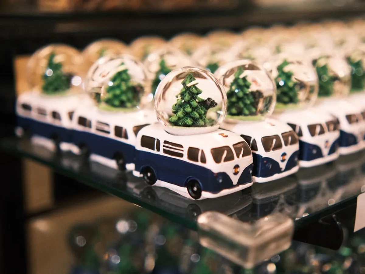 Camper van snow globes lined up on a store shelf